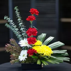 This modern design is memorable way to express sentiments. Flowers form a line of red with yellow and white finishing the design. For the non traditional, someone who needs that special design.