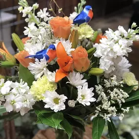 There's nothing like a Sweet Tweet to brighten someone's day! You don't need a reason to buy flowers for that special someone! Send them a Just Because Arrangement today!! Arrangement is filled with orange Lilies, Roses, white Stock, Daisies, and green Carnations. Color of birds may vary.