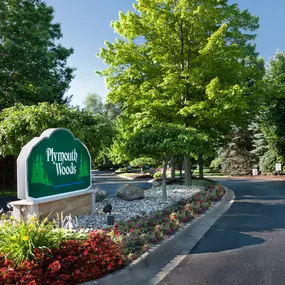 Signage welcoming guests at Plymouth Woods Apartments
