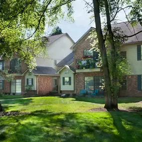 Lawn with trees of Plymouth Woods Apartments