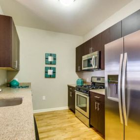 Modern Kitchen With Stainless Steel Appliances And Double Door Refrigerators