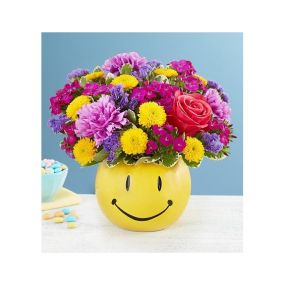 Helping you deliver smiles is what we do…and this feel-good bouquet is a great way to do it! Bunches of blooms in uplifting colors are gathered into our keepsake smiley face container, delivering just the brightness they need to make their day better. Perfect for celebration-worthy moments and everyday sentiments.