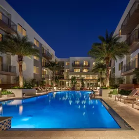 Palm-tree lined courtyard with heated pool and lounge areas at AVE Tampa Riverwalk