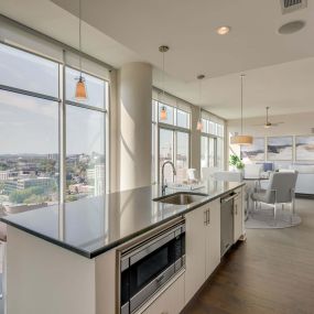 Camden Music Row Apartments Penthouse kitchen with island, floor to ceiling windows, room for dining, built-in appliances