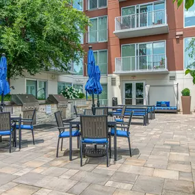 Grills and outdoor seating next to the pool