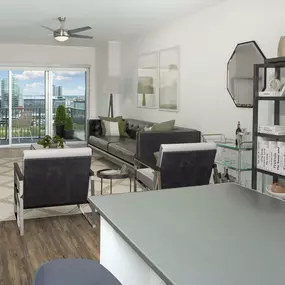 View from kitchen island into open-concept living room with balcony overlooking Downtown Nashville.