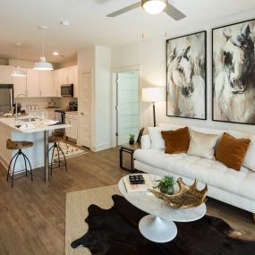 Gorgeous Modern Living Rooms with Barn-Style Lighting and Reclaimed Wood-Inspired Flooring at Echo at North Pointe Center Apartment Homes