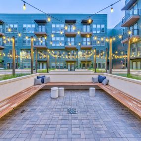 Courtyard seating at twilight with string lights overhead