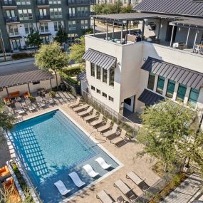 Aerial view of Villas pool and amenity building with rooftop lounge at Camden Greenville