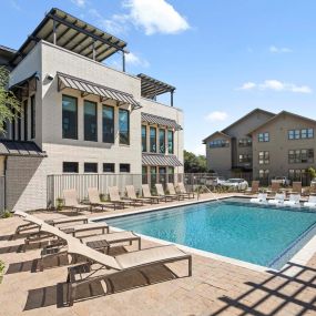 Villas pool and sundeck next to the amenity building at Camden Greenville apartments in Dallas, TX