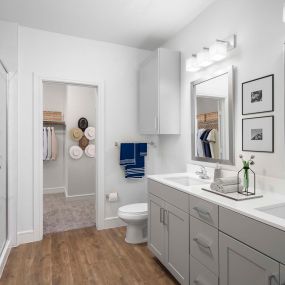 Villas townhome closet and bathroom with gray cabinets and two sinks at Camden Greenville