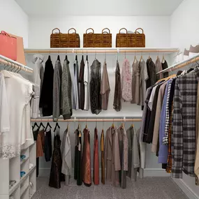 Large walk-in closet with built-in wood shelves and racks at Camden Greenville