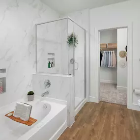 Villas townhome bathroom with gray cabinets, walk-in shower and bathtub at Camden Greenville