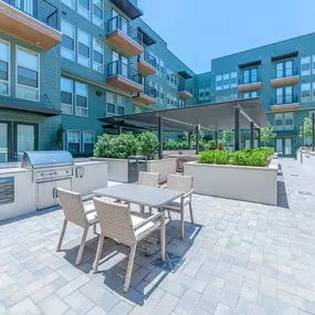 Courtyard with grill area and covered lounge seating at Camden Greenville apartments in Dallas, TX