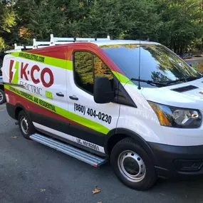 K-CO Electric service van parked at a residential job site, fully equipped for electrical installations and repairs.