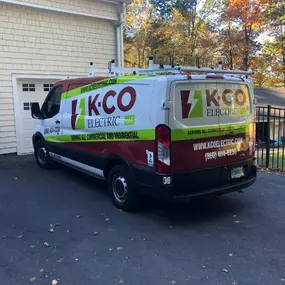 K-CO Electric service van parked at a residential job site, fully equipped for electrical installations and repairs.