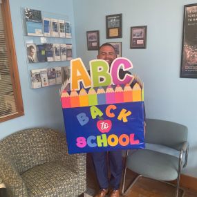 Our exclusive agent, Brian Pellone, getting weighed down and excited to bring down the box full of school supplies to our local Hampton Bays Elementary school.