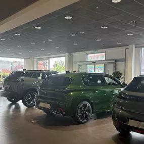 Evans Halshaw Peugeot Wakefield Dealership Interior Showroom Model Lineup from Rear