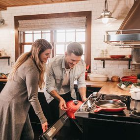 a couple cooking in an updated kithen