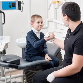 Pediatric dentist with a young patient