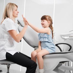 pediatric dentist with a young female patient