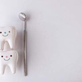 Pediatric dentist tools and enlarged teeth with smiles