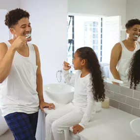 dad and daughter brushing together