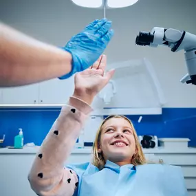 Girl high-fiving pediatric dentist