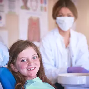 A young girl with a pediatric dentist