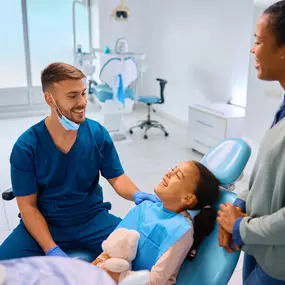 Dentist talking to a patient at Dr. Schweppe Pediatric Dentistry