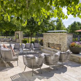 Poolside lounge with fireplace and tv at Camden Franklin Park apartments in Franklin, TN