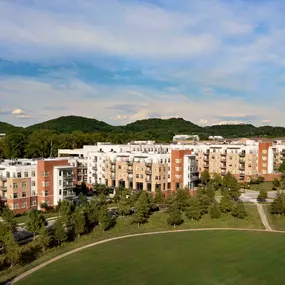 Exterior view of Camden Franklin Park with hills in the background and local park nearby.