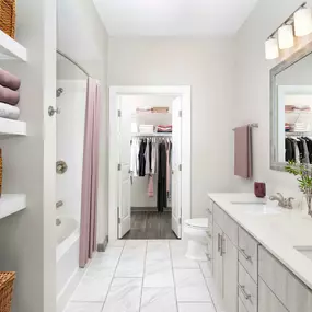 Bathroom with light finish, two sinks and walk-in closet at Camden Franklin Park