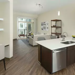 Kitchen with brown cabinetry, light countertops and built-in desk.