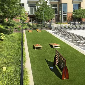 Poolside game area with cornhole at Camden Franklin Park apartments in Franklin, TN