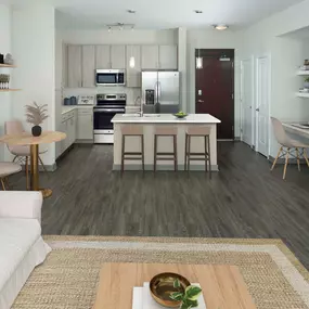 Open-concept one-bedroom living room and kitchen with light gray cabinetry and built-in desk.