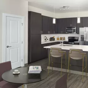 Kitchen and dining with dark finish and built-in desk at Camden Franklin Park