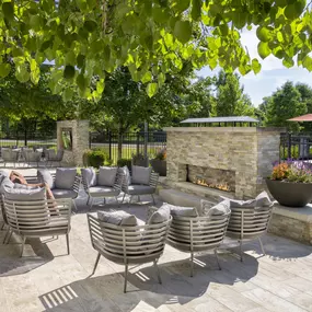 Poolside lounge with fireplace and tv at Camden Franklin Park apartments in Franklin, TN