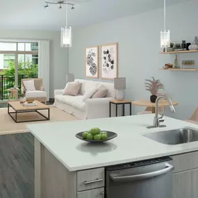 View from kitchen over island into open living room with balcony.