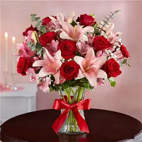 Let her know she’ll always hold the key to your heart with our magnificent Valentines arrangement. A show-stopping mix of radiant red & pink blooms, it’s hand-arranged inside a clear glass vase tied with a red satin ribbon.