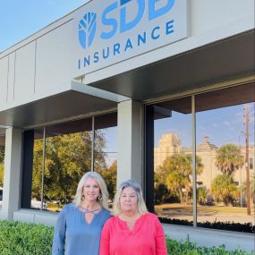 Employees standing outside SDB Insurance building.