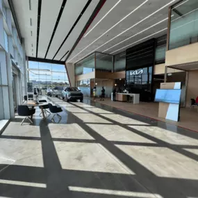 Lobby of Jeff Wyler Kia of Colerain in Colerain, OH, offering a comfortable customer lounge where drivers can relax while shopping new Kia vehicles, browsing pre-owned inventory, or waiting for service.