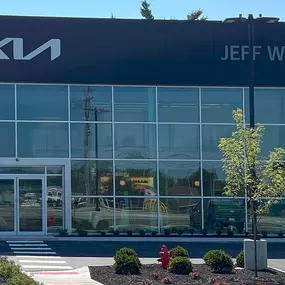 Close-up exterior view of Jeff Wyler Kia of Colerain dealership building in Colerain, OH, proudly serving Kia customers near Cincinnati with new and pre-owned vehicles.