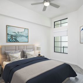 The penthouse bedroom features high ceilings and an LED ceiling fan at Camden Central apartments in St Petersburg, Florida.