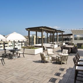 Eighth-Floor Rooftop Terrace with BBQ Grills and expansive seating at Camden Central Apartments in St. Petersburg, Florida.