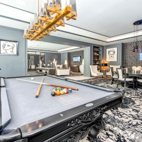 Join a game of pool at the billiards table in our Resident Lounge at Camden Central Apartments in St. Petersburg, FL.