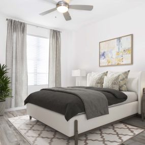 The bedroom with a LED ceiling fan and wood-look flooring at Camden Central apartments in St. Petersburg, Florida.