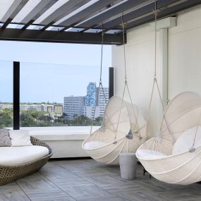 Eighth-Floor Rooftop Terrace swinging chairs at Camden Central apartments in St. Petersburg, Florida.