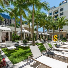 Private cabanas and plenty of lounge chairs at the tropical pool at Camden Central Apartments in St. Petersburg, FL.