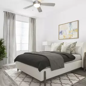 The bedroom with a LED ceiling fan and wood-look flooring at Camden Central apartments in St. Petersburg, Florida.